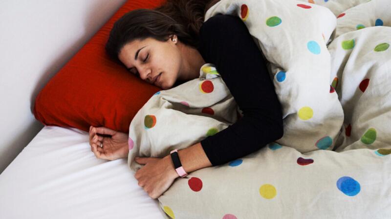 A woman is sleeping in a bed.