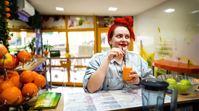 Woman enjoying a drink at a juice bar