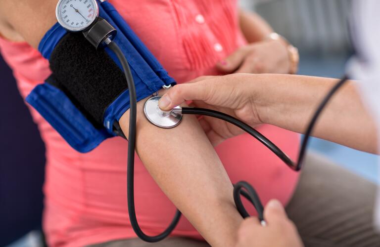 Close-up of Caucasian woman getting blood pressure check