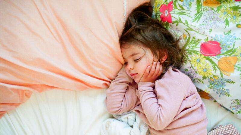A little girl is lying down.