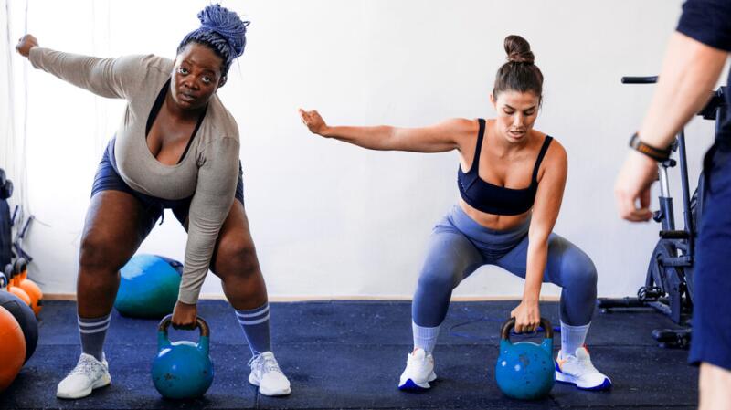 Two women exercising with kettle bells