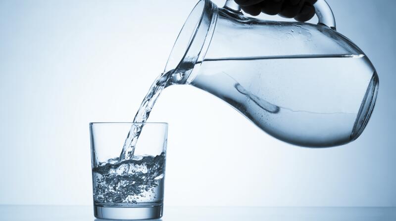 pitcher of water being poured into glass