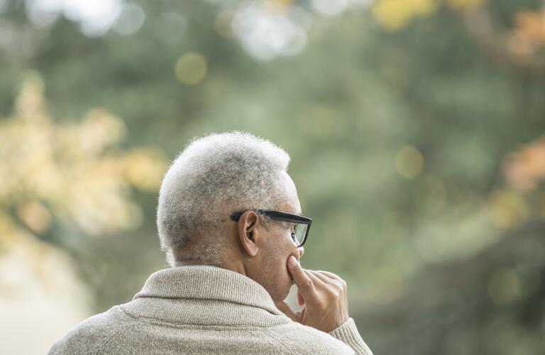 senior-black-man-sitting-in-wheelchair-rear-view