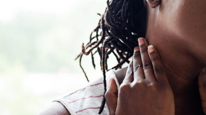 Woman touching her neck