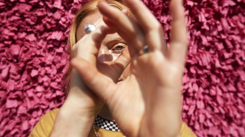 A woman making a ring with her fingers