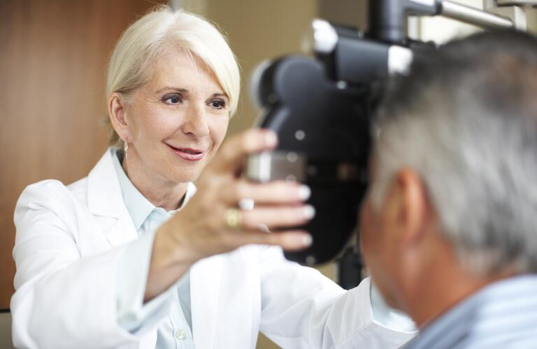 female eye doctor checking patient's vision