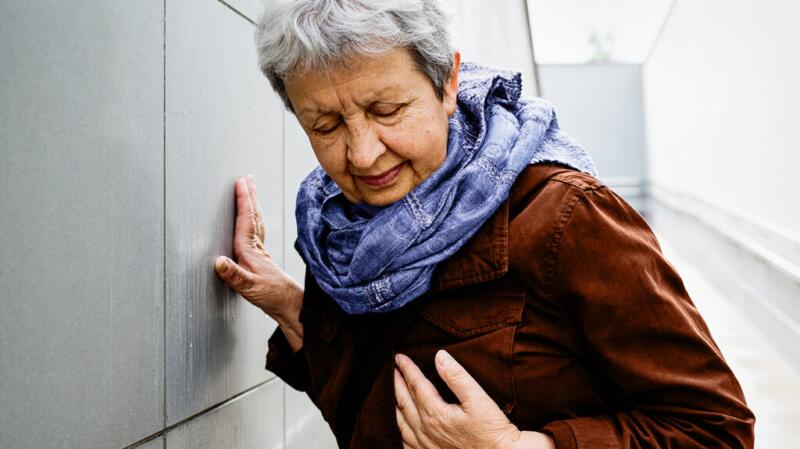 A woman has her hand on her chest.