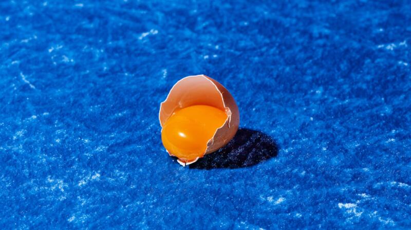 there is an egg yolk against a blue background