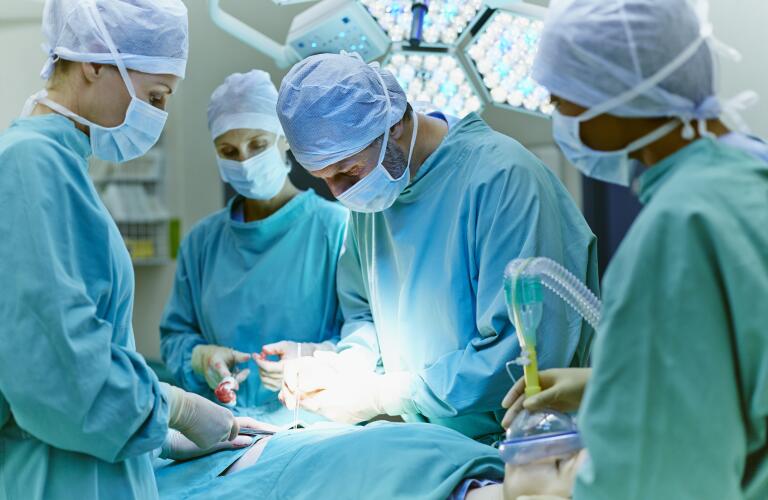 Surgeons Standing Over Patient