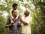 happy African American father son and grandfather on hike
