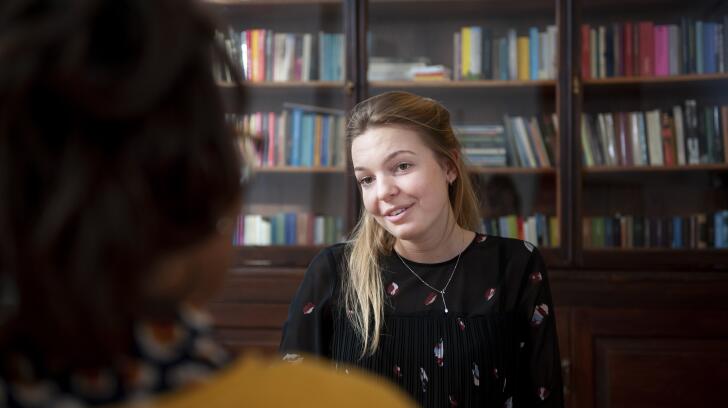Young Caucasian woman talking to counselor in office