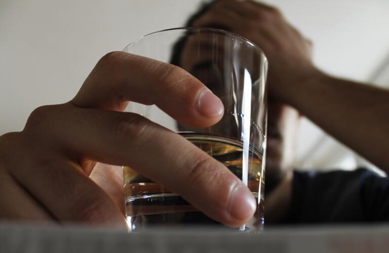 Close-up bottom view of Caucasian male holding alcoholic drink