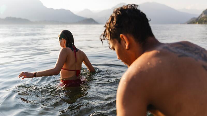a young couple are swimming