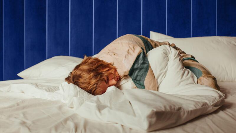 A person in pain lying in bed