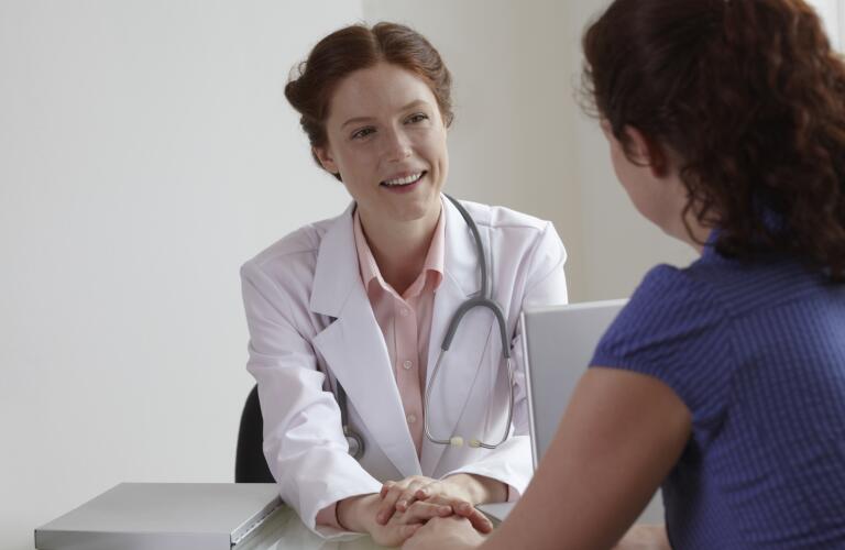 female doctor comforting female patient