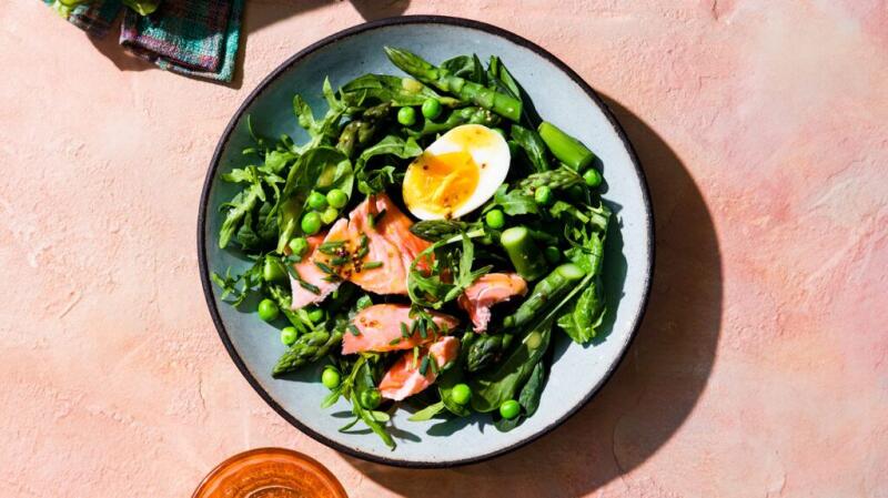 A salad with salmon and a hard-boiled egg