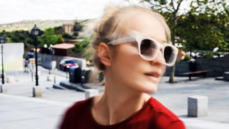 Female with sunglasses turning her head