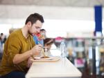 guy eating at airport