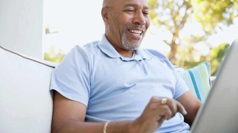 senior-man-on-laptop-outdoors