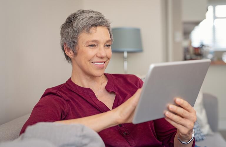 Women sitting on couch with laptop