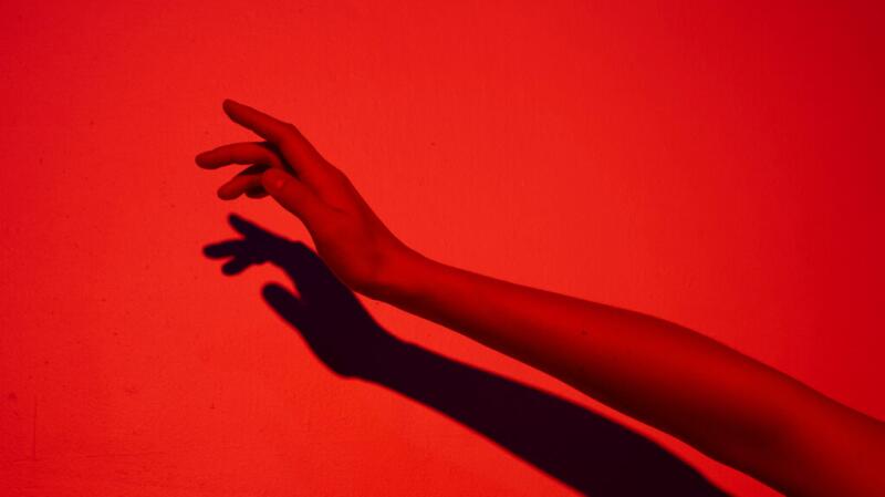 A closeup of an arm in red light