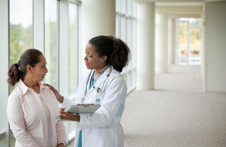 doctor talking to female patient