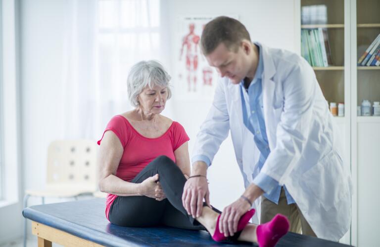 Doctor examining patient's leg