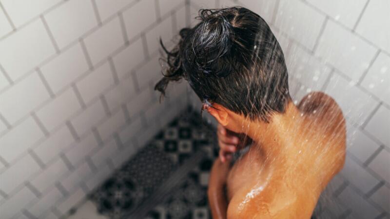 young man showering