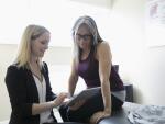 female patient looking at tablet with doctor