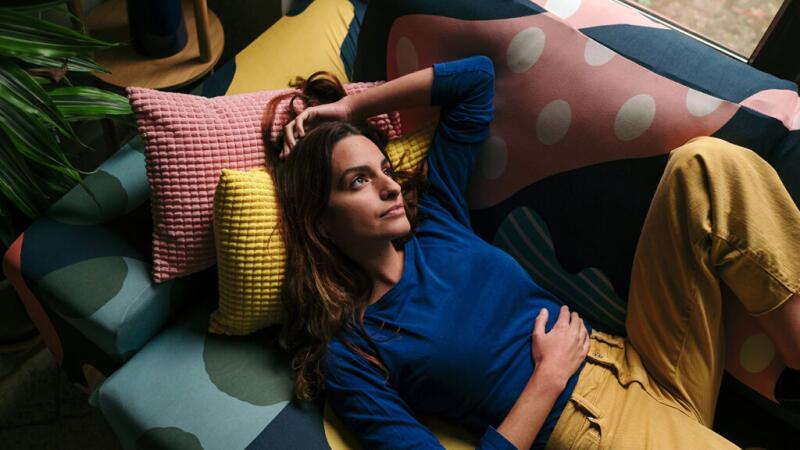 A woman lying down with her hand on her stomach