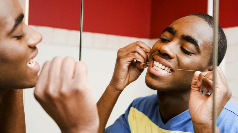 Person flossing their teeth