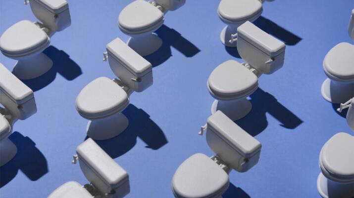 there are toilets against a blue background