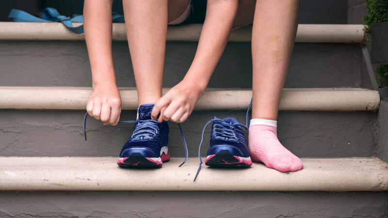 a person is tying their shoe