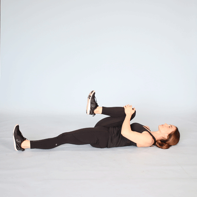 a person is performing the knees to chest stretch