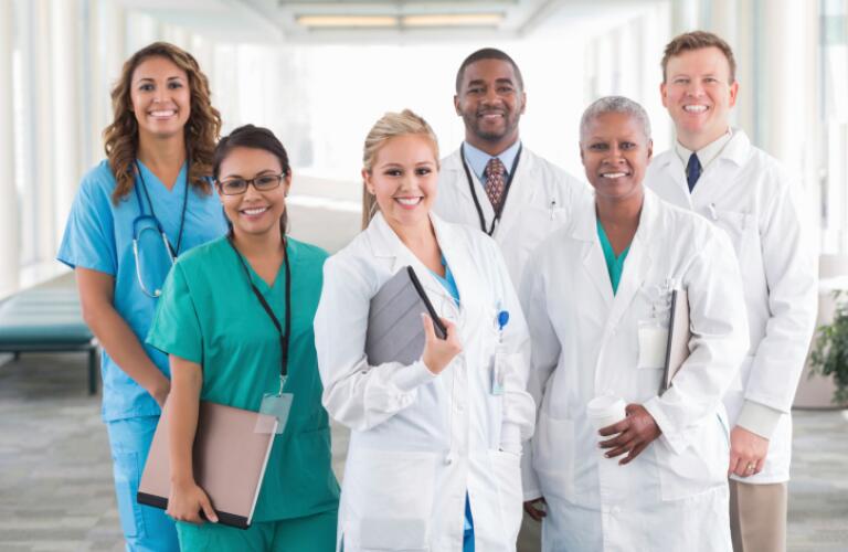 Large diverse group of hospital doctors, surgeons, and nurses