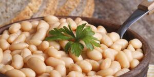 White kidney beans in a brown pot macro and bread