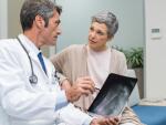 senior woman looking at bone xray with doctor