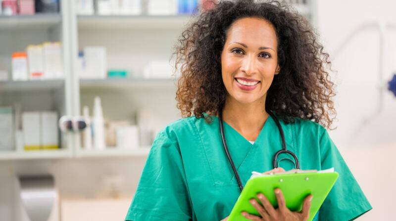 Portrait-of-medical-worker-writing-on-clipboard-in-clinic