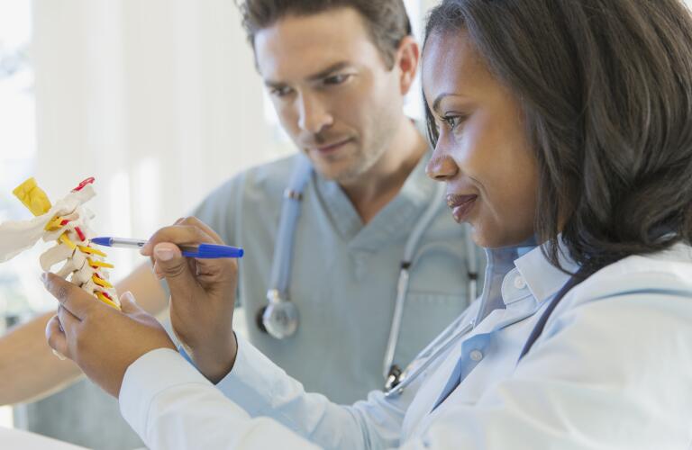 doctors-looking-at-spine-model