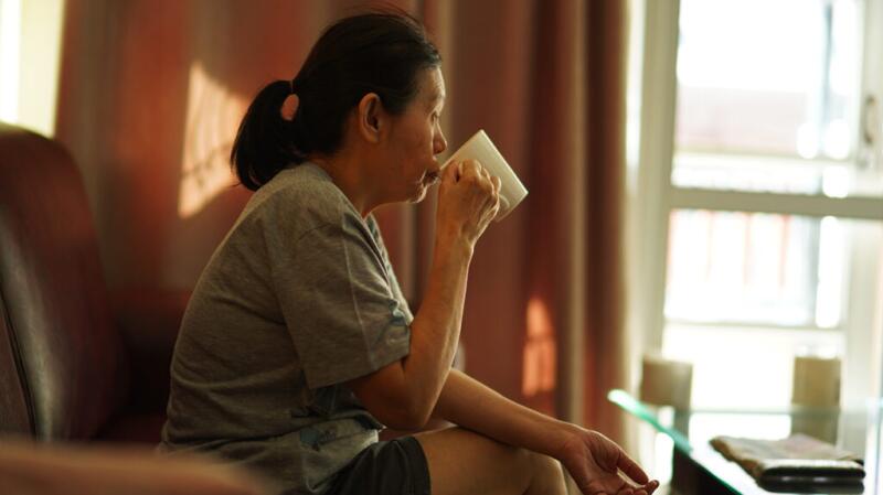 a woman is drinking to stay hydrated
