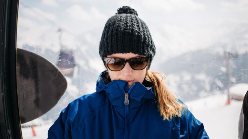 Woman outdoors on ski mountain wearing sunglasses
