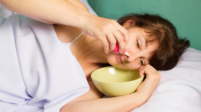 woman flushing her nose with saline