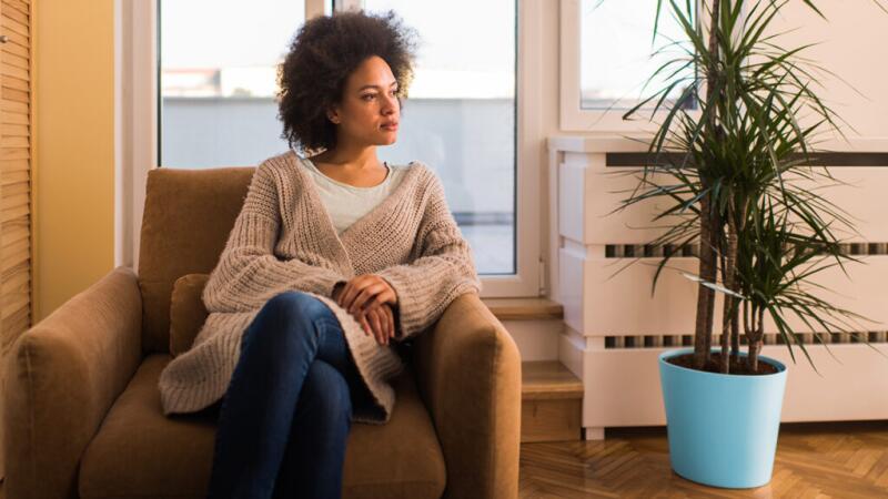 Woman sitting in a chair looking out the window