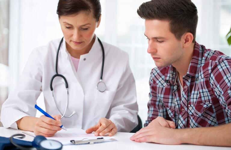 young male patient reviewing results with doctor