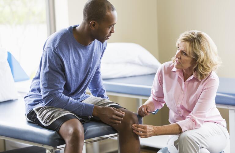 man-having-knee-checked-out-by-doctor