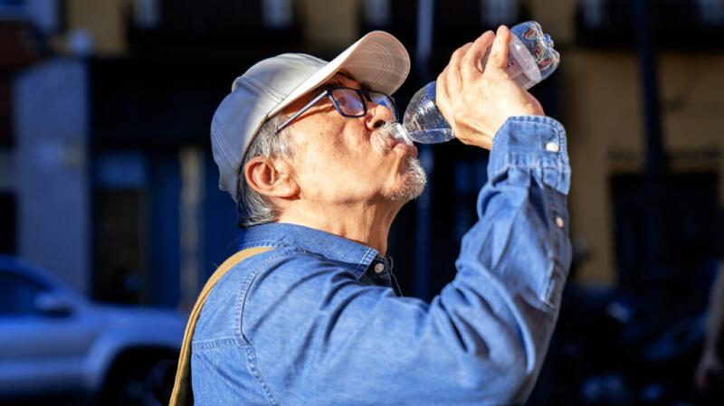 a man with kidney stones is drinking water