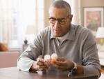 Mixed race man examining prescription bottles