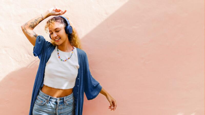 A woman wearing headphones in the sun
