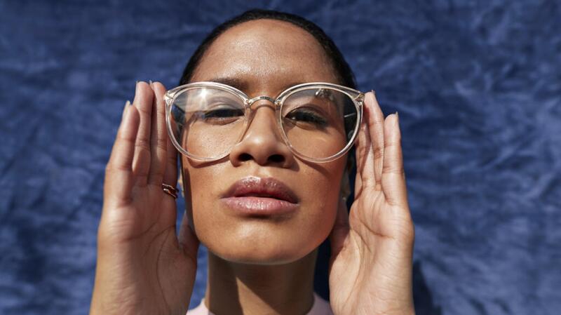 A female adult places glasses over her eyes.