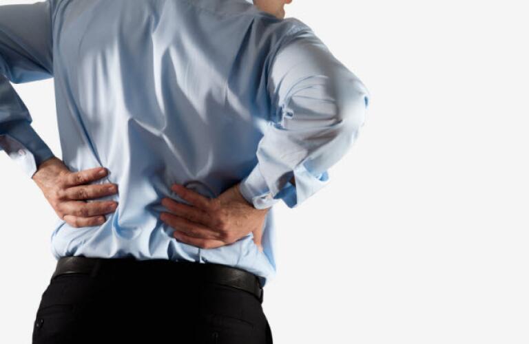man holding his back